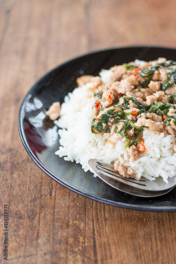 Thai food, rice topped with stir-fried pork and basil. Thai food, rice topped with stir-fried pork and basil.