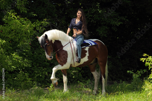 Native American Indian girl on horseback in the bush
