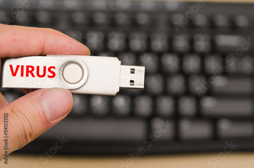Hand hold blank USB virus thumb drive or virus USB stick with ke