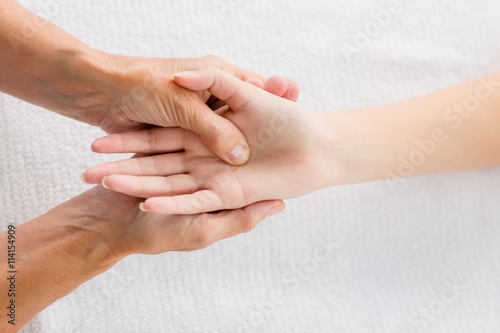 Photography Cropped image of masseur massaging woman hand