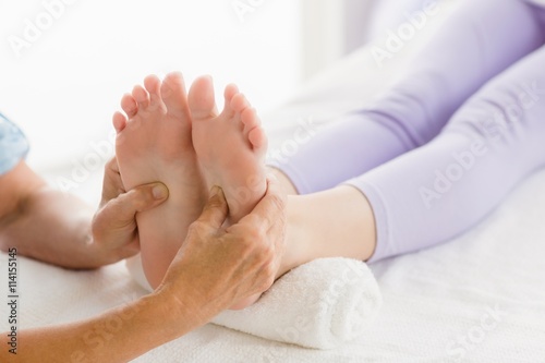 Cropped image of masseur giving foot massage to woman © WavebreakMediaMicro