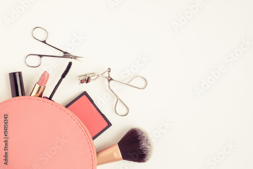 Top view of cosmetic bag with makeup items