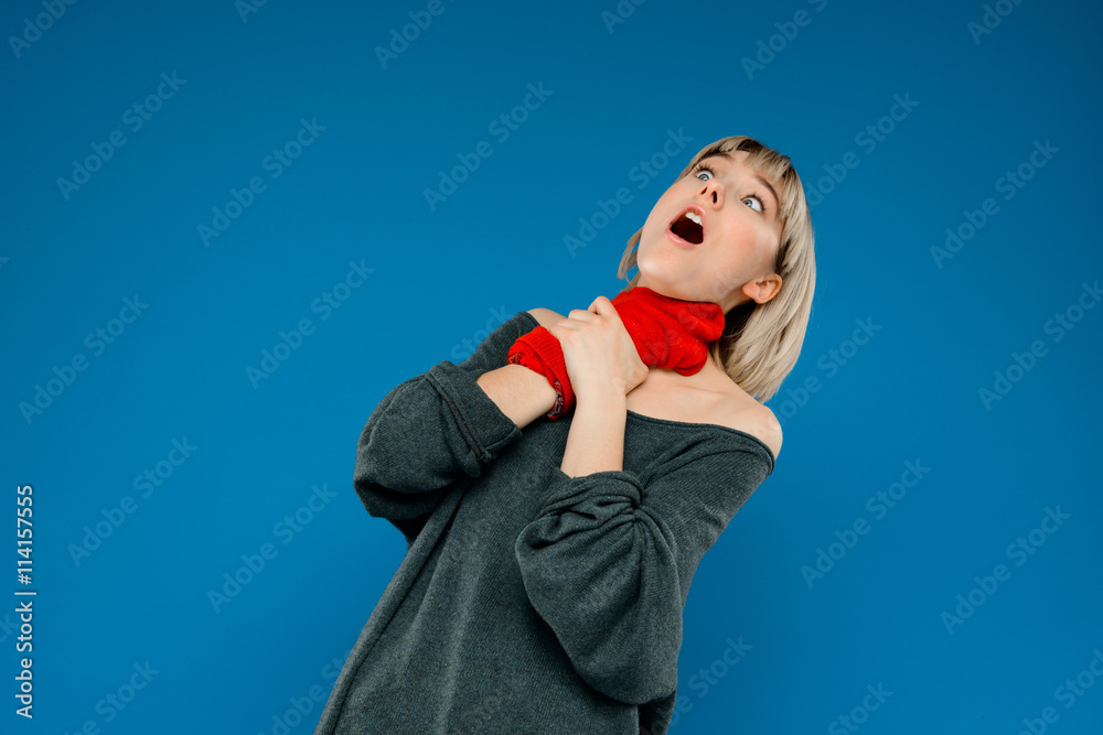 Portrait of young girl fooling in gloves over blue background. Portrait of young girl fooling in gloves over blue background.