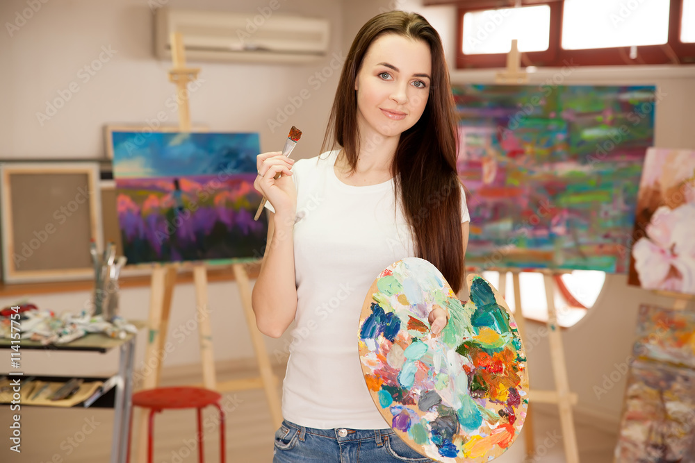 Female Artist Working On Painting In Studio Female Artist Working On Painting In Studio