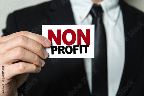 Business man holding a card with the text: Non Profit photo