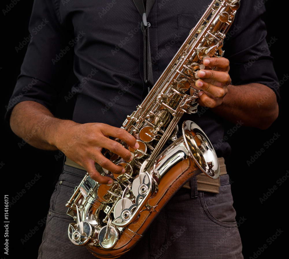 Obraz premium Close up of nice saxophone, silver one with someone touching it