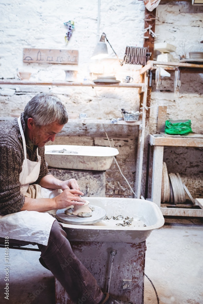 Craftsman concentrating while working in workshop Craftsman concentrating while working in workshop