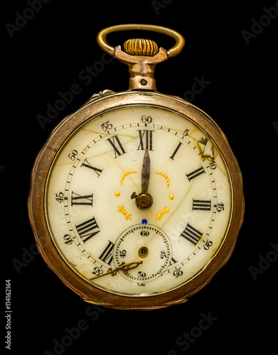 Antique back cover pocket watch isolated on a pure black background.