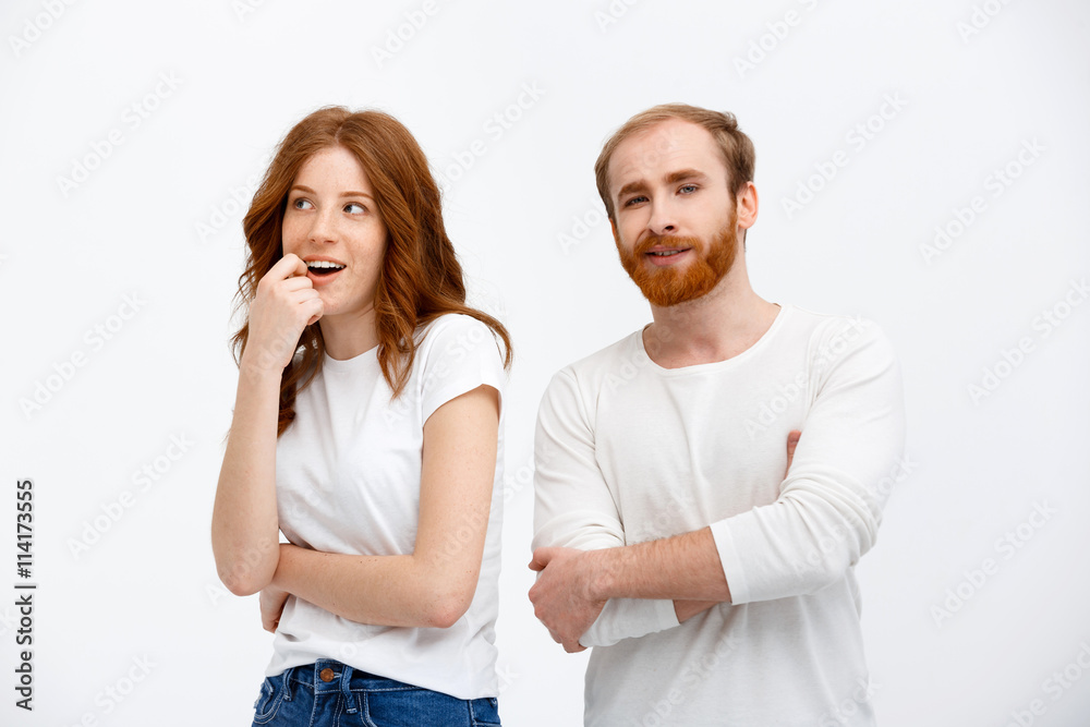 Beautiful redhead girl and boy standing over white background Beautiful redhead girl and boy standing over white background