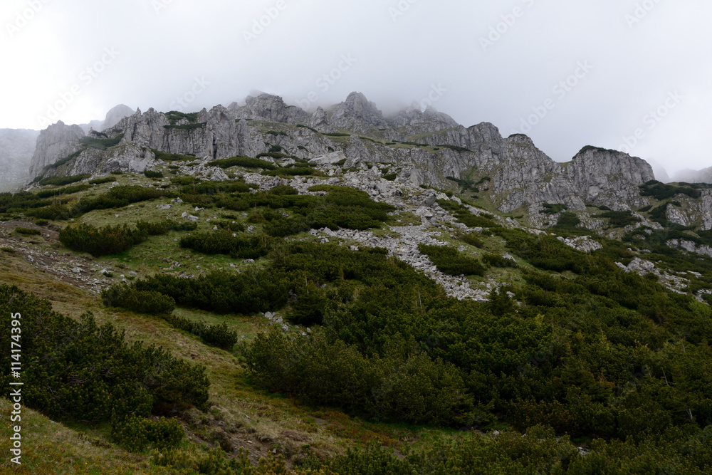 Stones and rocks on mountainside in fog