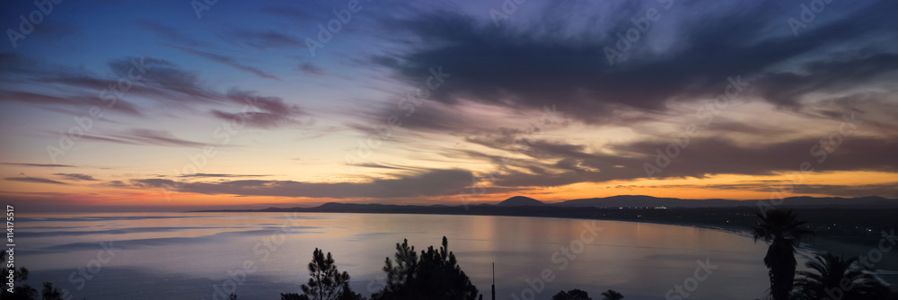 Ocean coast panorama with water and sunset sky