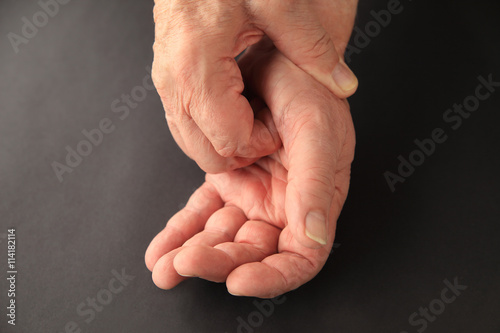 Older man scratching his palm