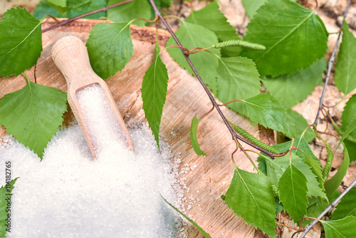 Xylitol birch sugar on a birch background