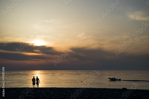 The image of two people in love at sunset © romankosolapov
