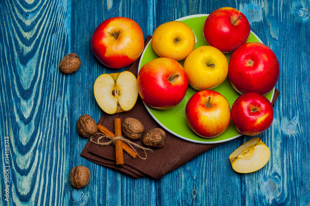 walnut apples and cinnamon on blue wood walnut apples and cinnamon on blue wood