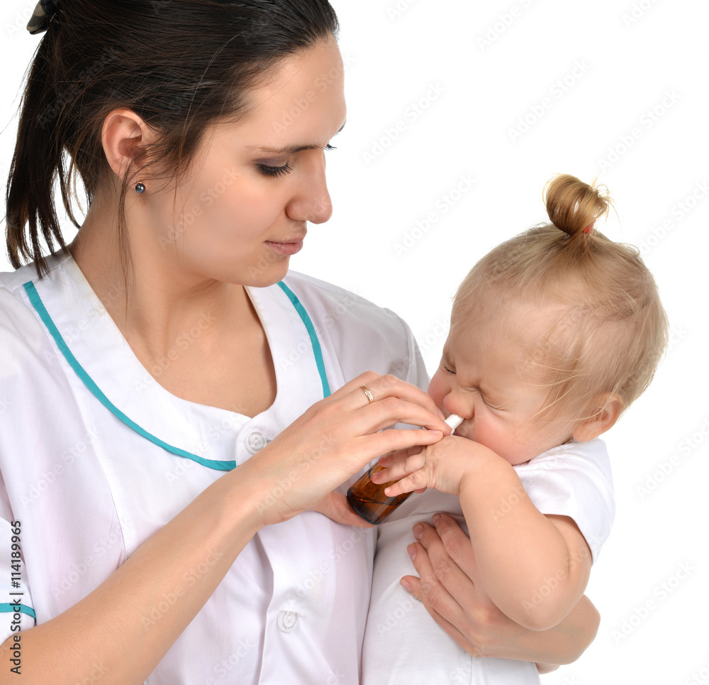 Woman hand using medicine nose spray nasal for baby toddler chil Woman hand using medicine nose spray nasal for baby toddler chil