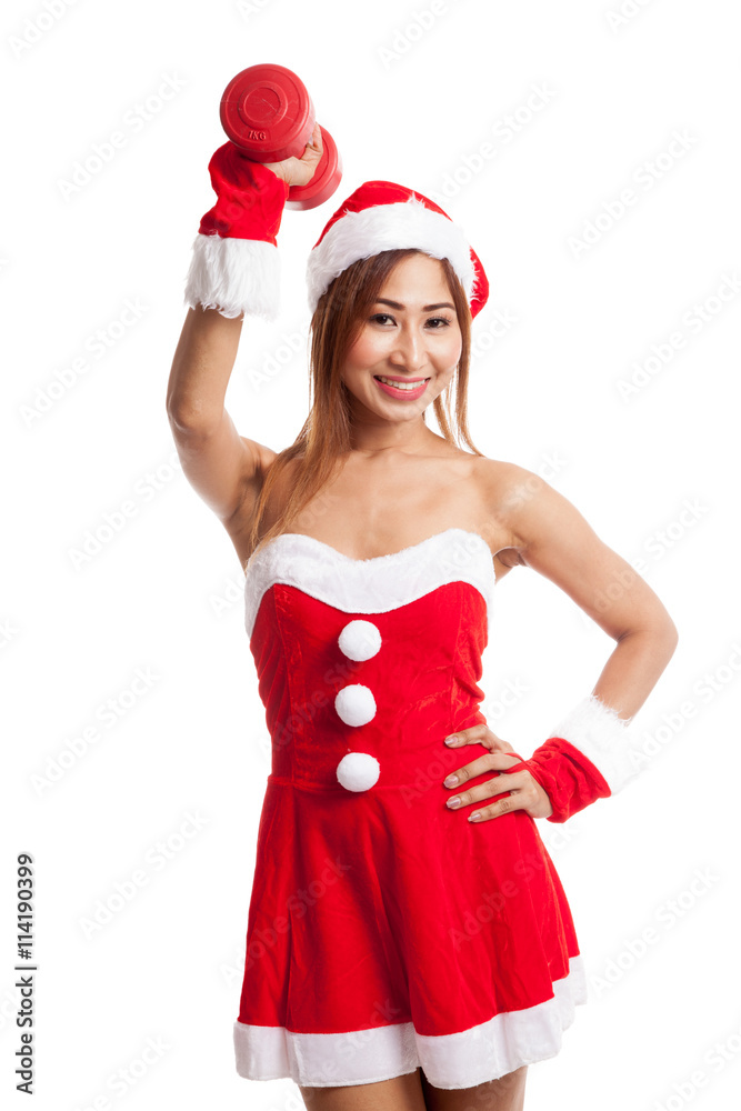 Asian Christmas girl with Santa Claus clothes and red dumbbell Asian Christmas girl with Santa Claus clothes and red dumbbell