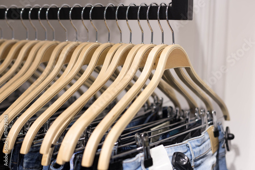 Clothes hang on a shelf in a designer clothes store