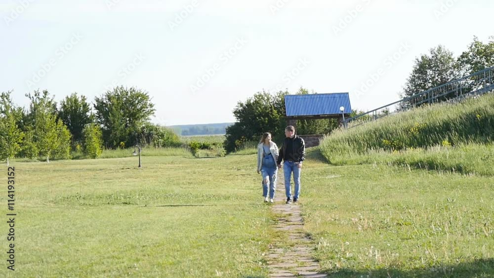 Pregnant woman with husband walking Pregnant woman with husband walking