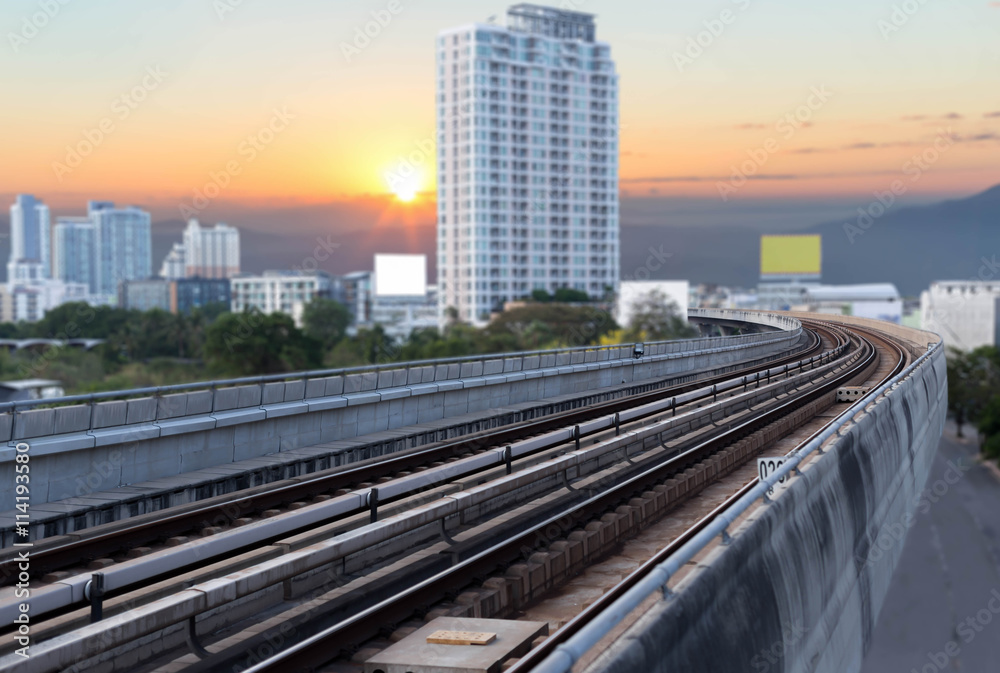 Skytrain rails with residence area and sunset light