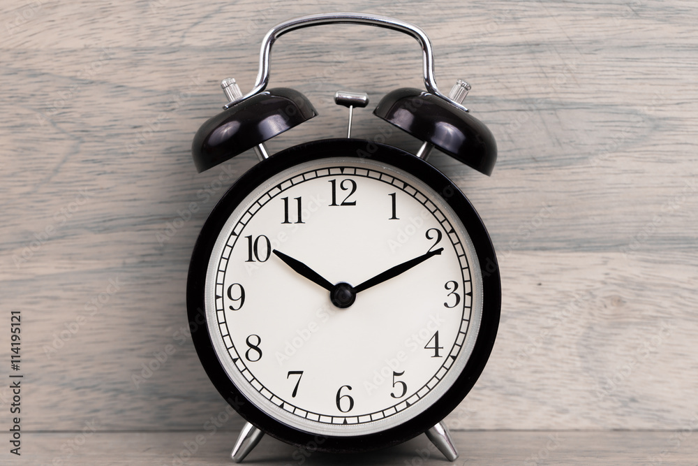 Alarm clock on wood background Alarm clock on wood background