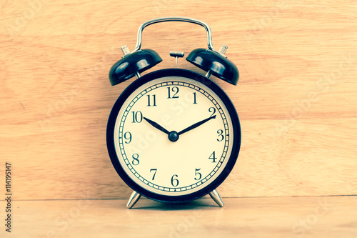 Alarm clock on wood background