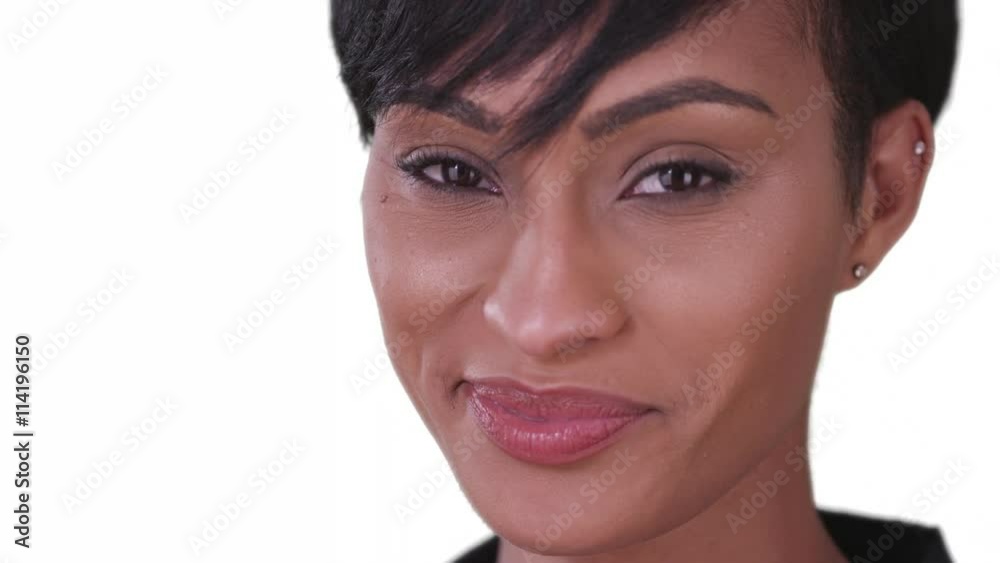 Happy smiling black woman on white background looking at camera. Close up of beautiful African American millennial in her 20s. Happy smiling black woman on white background looking at camera. Close up of beautiful African American millennial in her 20s.