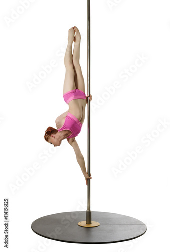 Pole dance. Flexible girl posing while exercising
