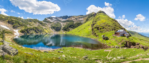 Beautiful mountain panorama with lake and mountain hut in Tyrol,