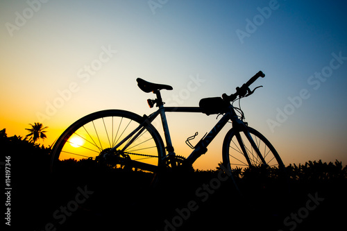 Silhouette bicycle with sunset sky