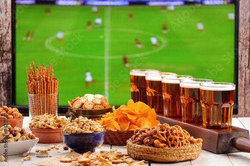 Football match television transmission with beer and snacks fan