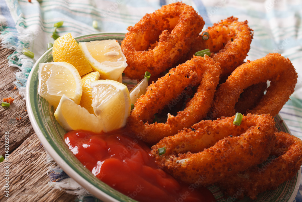 fried calamari rings close up with ketchup and lemon. Horizontal
fried calamari rings close up with ketchup and lemon. Horizontal
