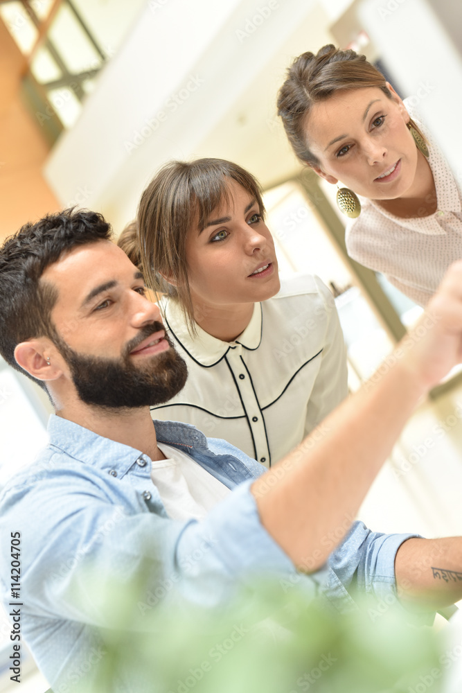 Fototapeta premium team of designers working on desktop