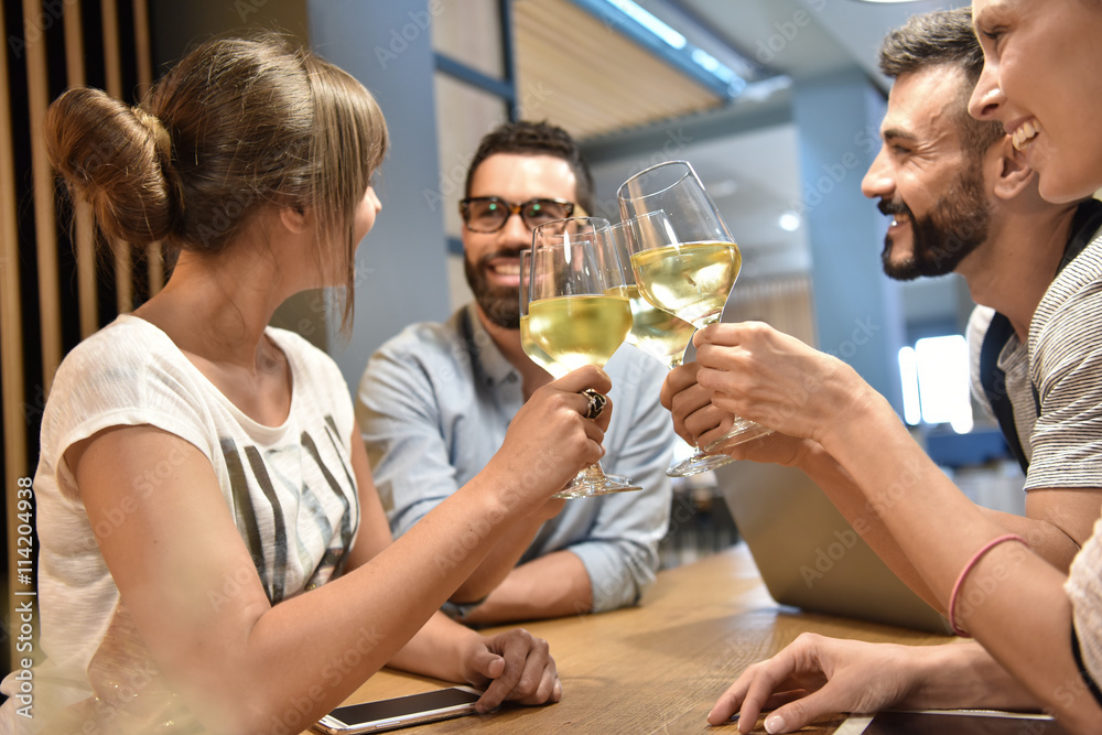 Group of young people cheering with wine glasses Group of young people cheering with wine glasses