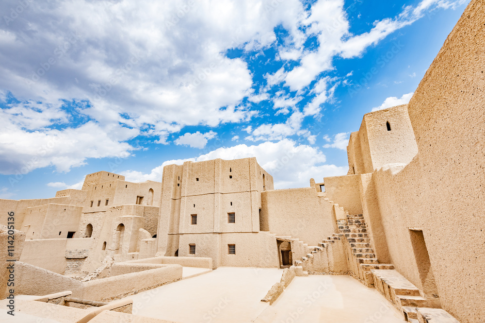 Bahla Fort in Ad Dakhiliyah, Oman. It is located about 40 km away from Nizwa and about 200 km from Muscat the capital. It has led to its designation as a UNESCO World Heritage Site in 1987. Bahla Fort in Ad Dakhiliyah, Oman. It is located about 40 km away from Nizwa and about 200 km from Muscat the capital. It has led to its designation as a UNESCO World Heritage Site in 1987.