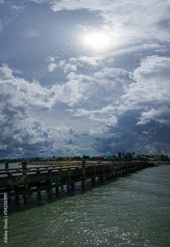 sea bridge and rainy clouds with a sun and lens flare after raining  prachuapkhirikhan province  thailand