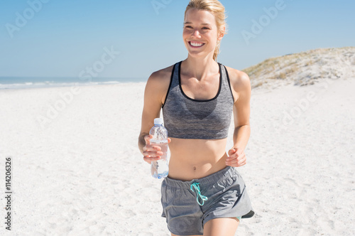 Fototapeta Naklejka Na Ścianę i Meble -  Running woman at beach