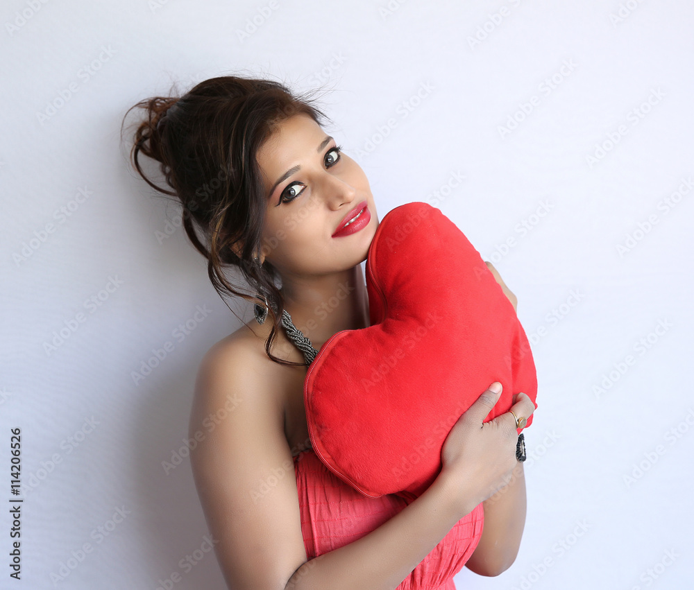 Attractive smiling indian woman isolated on white background with heart Attractive smiling indian woman isolated on white background with heart