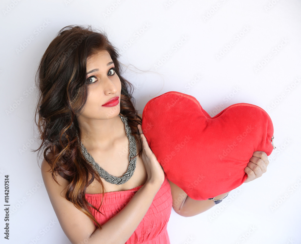 Attractive smiling indian woman isolated on white with heart. Attractive smiling indian woman isolated on white with heart.