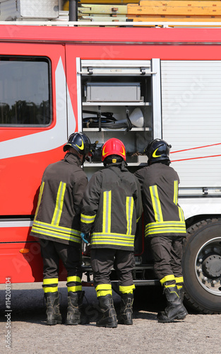 brave firefighters with fire engine truck