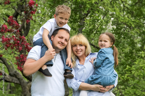 Happy family with two children in garden