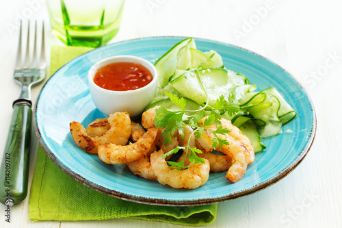 Salad with cucumber Asian style with fried shrimp.