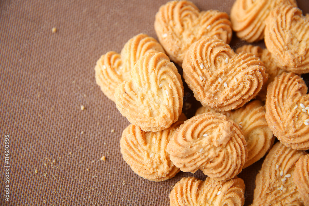 Cookies in heart shape with wooden basket on wooden background Cookies in heart shape with wooden basket on wooden background
