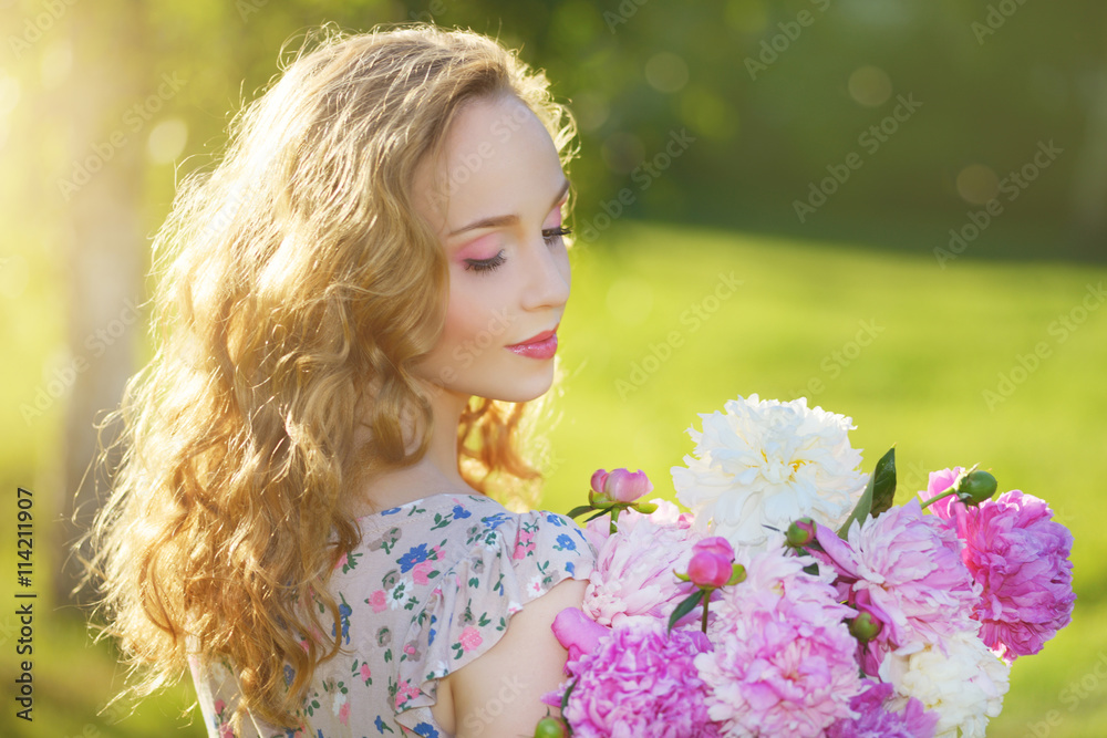 Fototapeta premium Girl with peony flowers