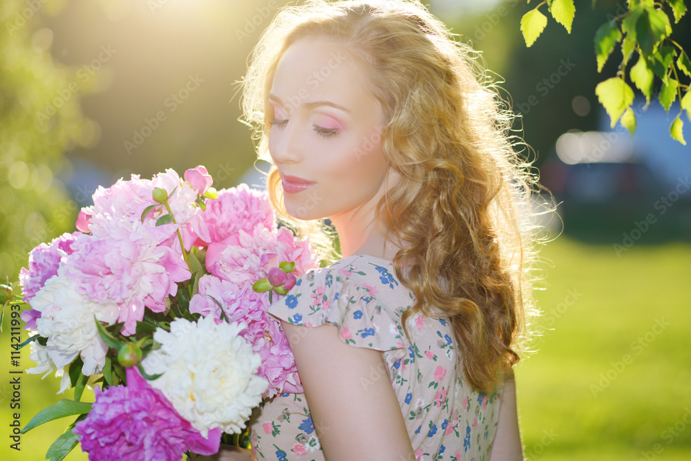 Fototapeta premium Girl with peony flowers