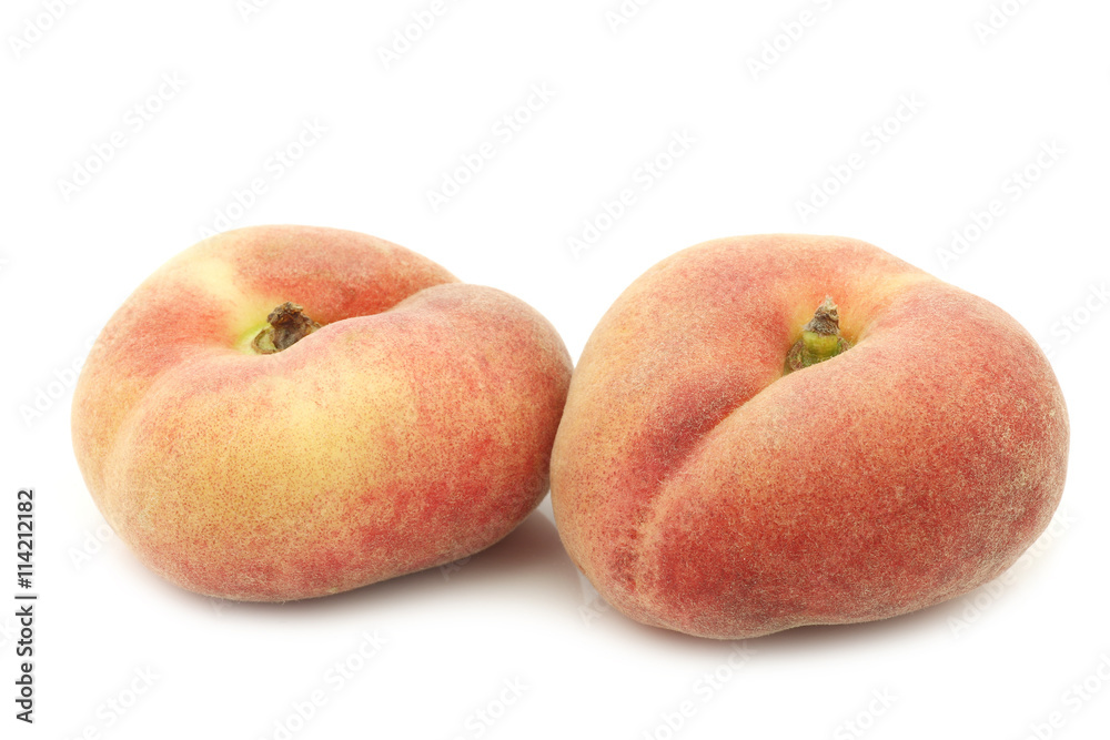fresh colorful flat peaches (donut peaches) on a white background fresh colorful flat peaches (donut peaches) on a white background