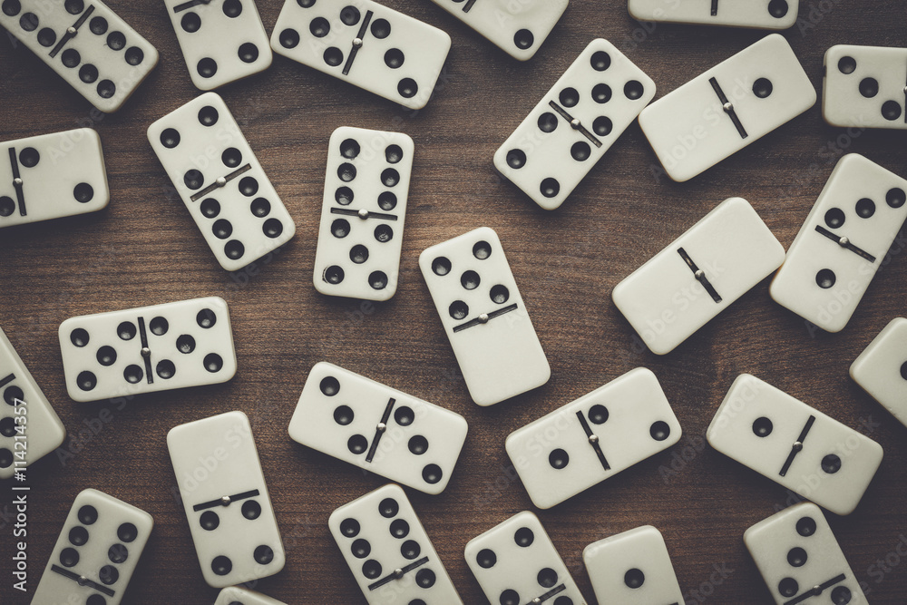 domino pieces on the brown wooden table background domino pieces on the brown wooden table background