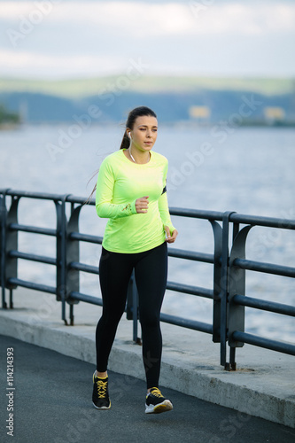 Running woman. Female Runner Jogging during Outdoor Workout in a Park. Beautiful fit Girl. Fitness model outdoors. Weight Loss