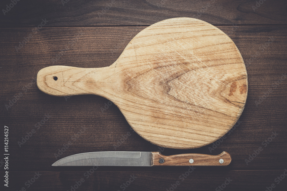 used cutting board on the wooden table with knife used cutting board on the wooden table with knife