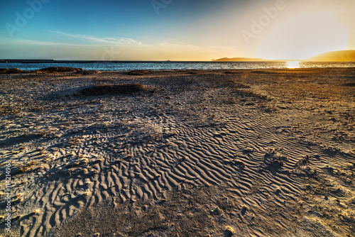 sandy shore in Alghero at sunset